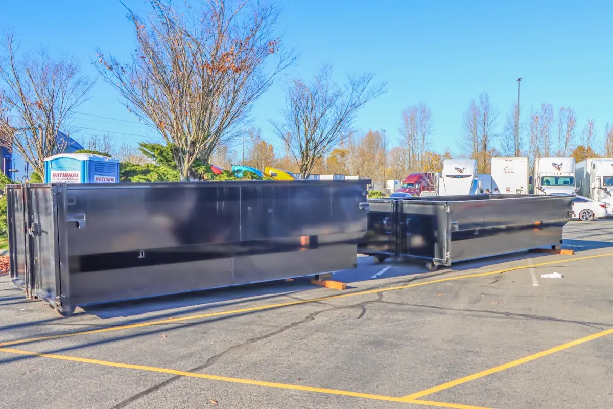 Professional dumpster rental service with roll-off container on residential driveway in Swampscott